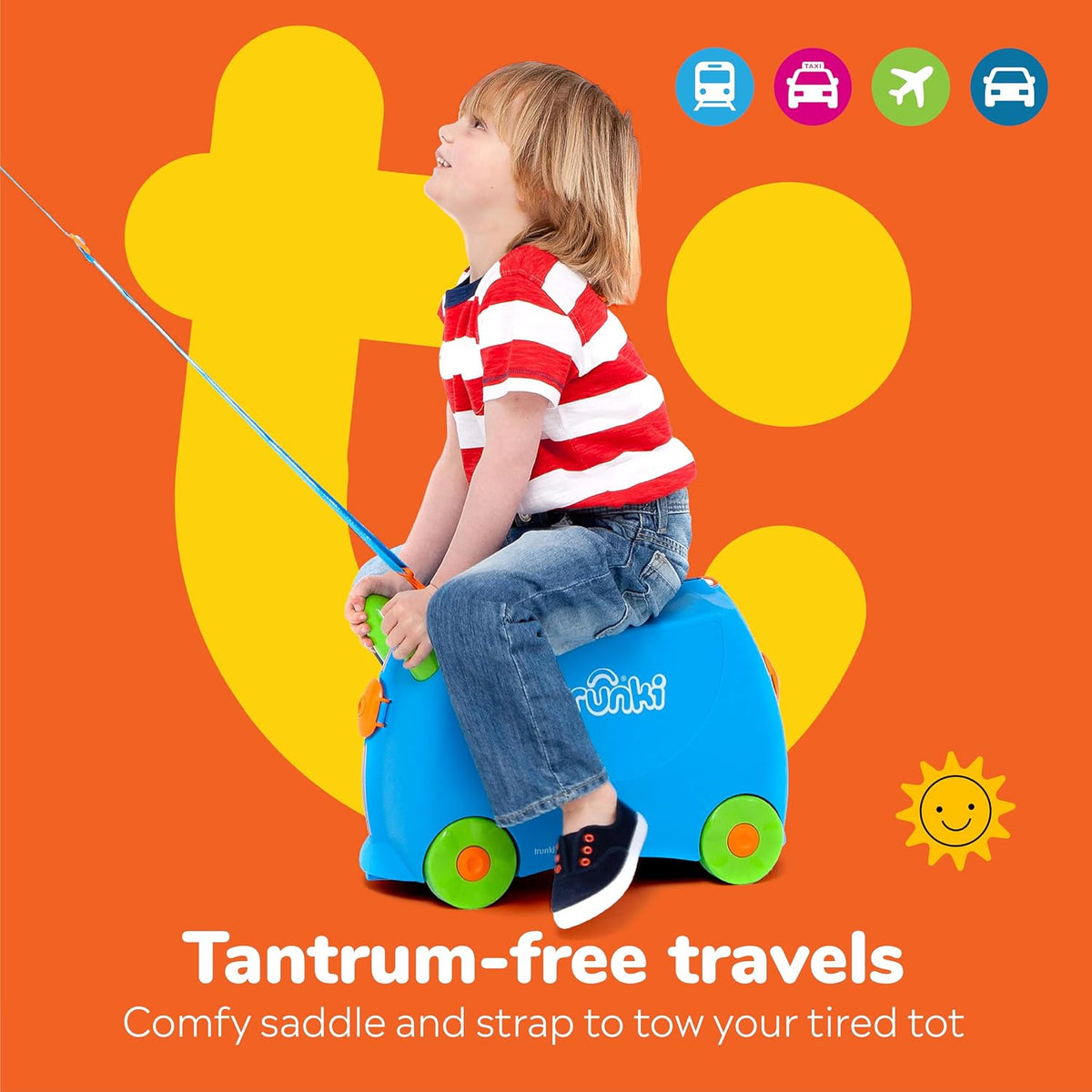 Parent towing toddler sitting on blue Terrance Trunki suitcase at airport terminal