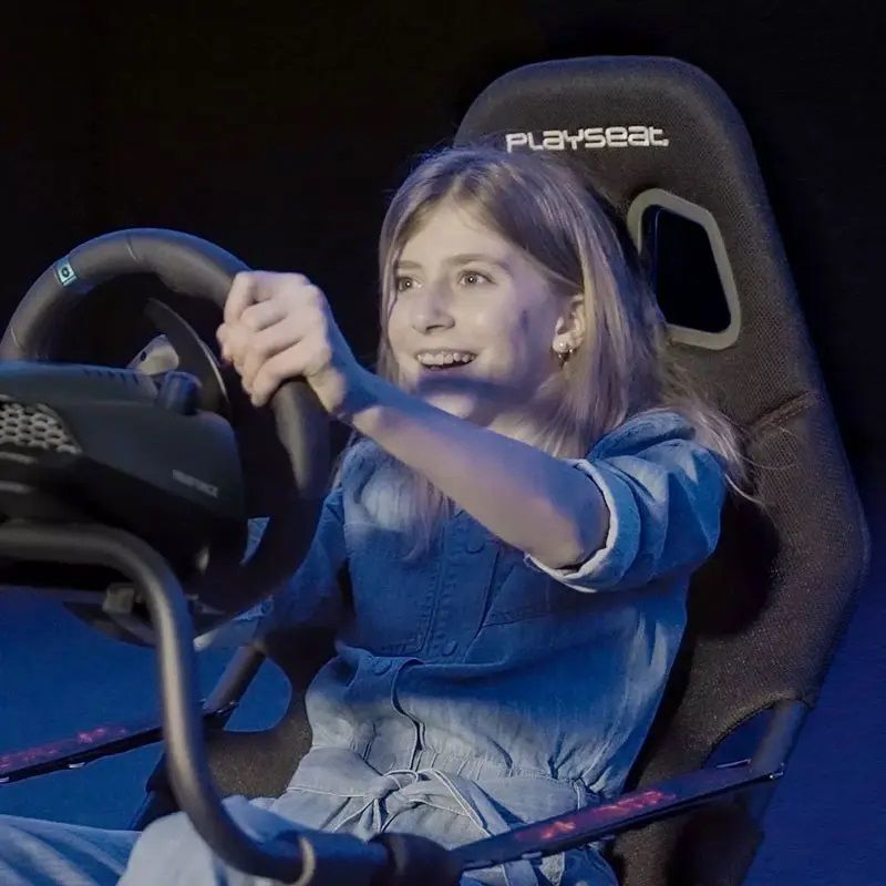 Playseat Evolution racing simulator cockpit with adjustable frame and alcantara seat.