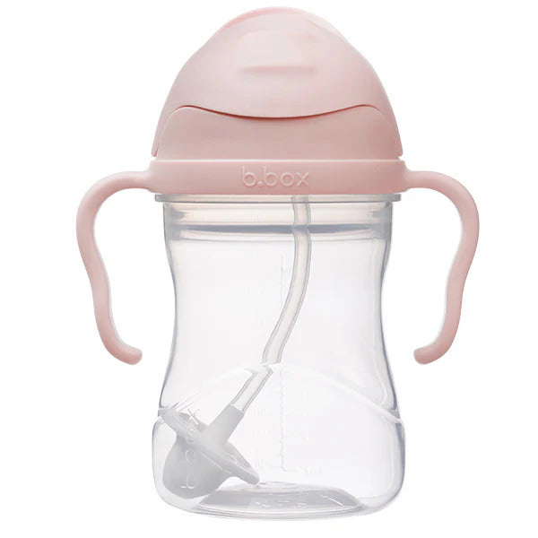 Pink sippy cup with handles on a white background
