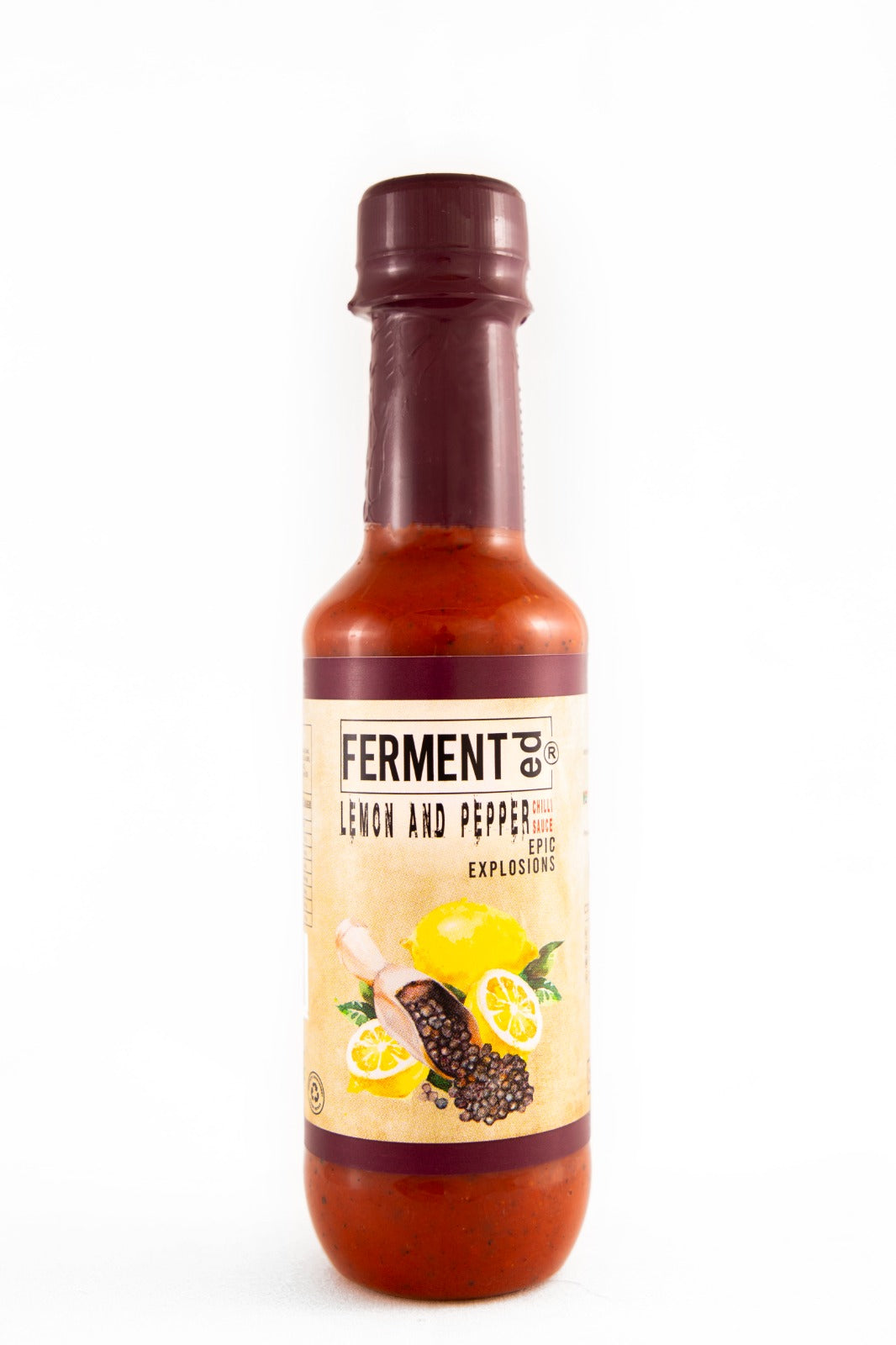Fermented Lemon And Pepper Chilli Sauce Epic Explosions 250ml

FERMENTed Lemon &amp; Pepper Chilli Sauce: Zesty Elevation of Heat
Our FERMENTed Lemon &amp; Pepper Chilli Sauce begins with a careful selection of cherry chillies, fermented to intensify their heat. The infusion of fermented lemon adds a zesty twist, while black pepper brings a sophisticated warmth to the blend.