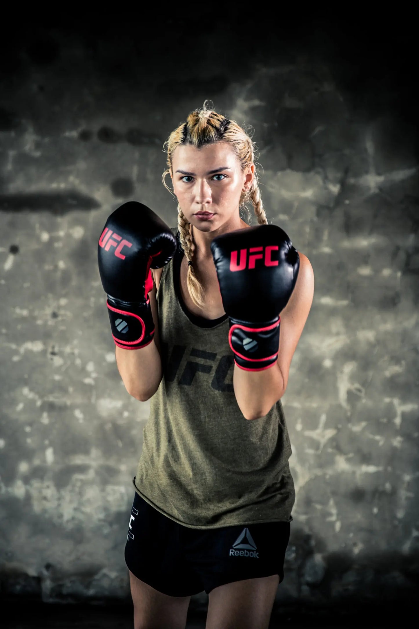 UFC Muay Thai Style Training Gloves
DON’T JUST FUNCTION, PERFORM

Enhance your endurance, strength and sparring skills with this high-energy impact dispersing Thai-style training glove. The internal hand compartment offers a secure, snug fit without sacrificing comfort. Layers of high-density moulded foam keep hands protected during heavy sparring and bag workout sessions. Rigid wrap-around hook &amp; loop closure supports wrist.