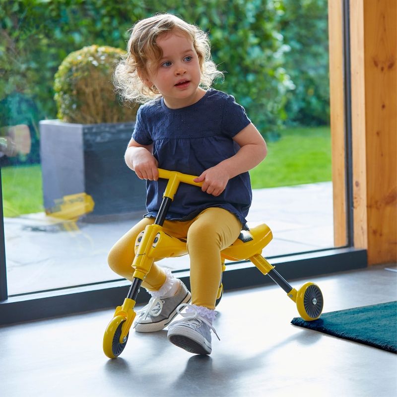 Yellow Scuttlebug tricycle shown in its 3-click folded position for storage