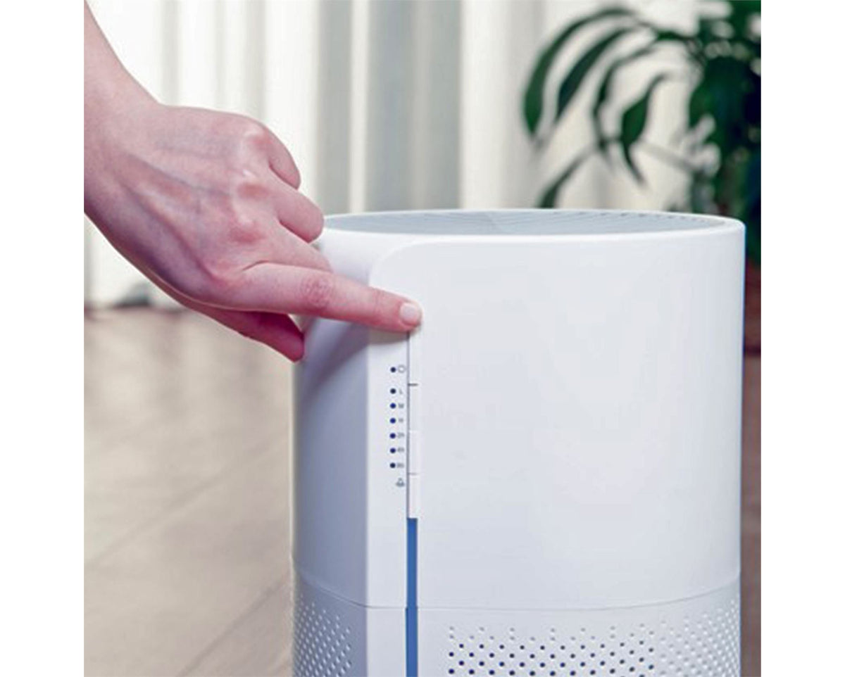 Taurus AP2030 white air purifier placed on a nightstand in a quiet bedroom setting