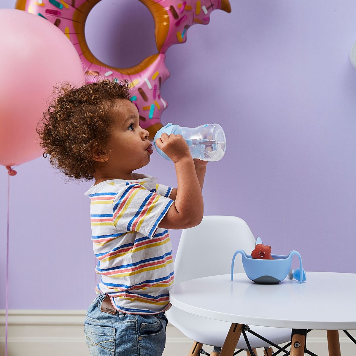 Toddler using easy-grip handles on a B.Box sippy cup for independent drinking