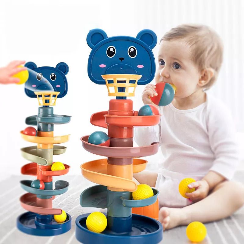 Toddler dropping balls into the Kids-Up rotating ball tower for motor skills