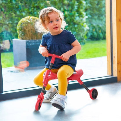 Toddler using a Scuttlebug ride-on bike on indoor flooring