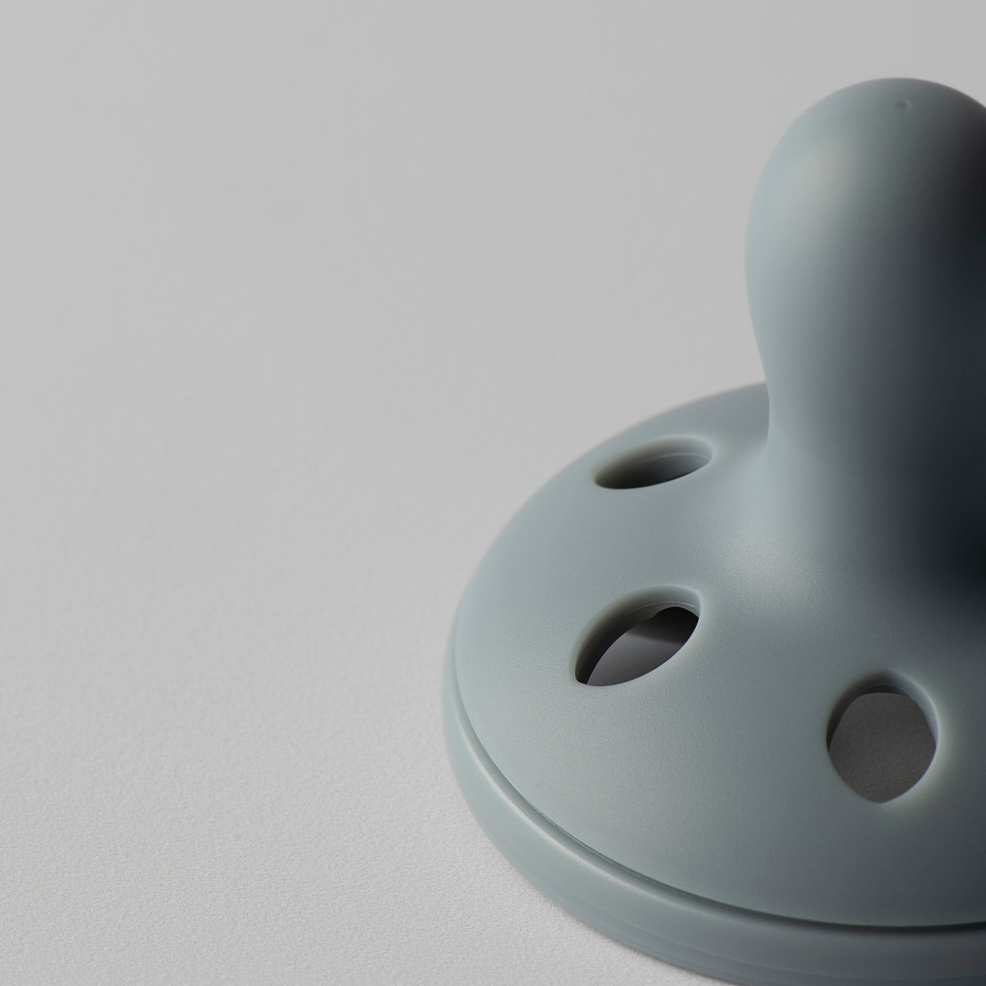 Side profile view showing curved facial shield on Tommee Tippee breastlike soother