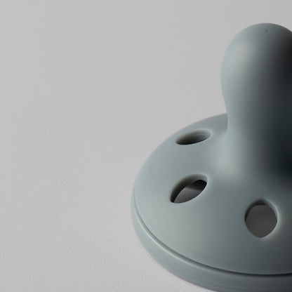 Side profile view showing curved facial shield on Tommee Tippee breastlike soother